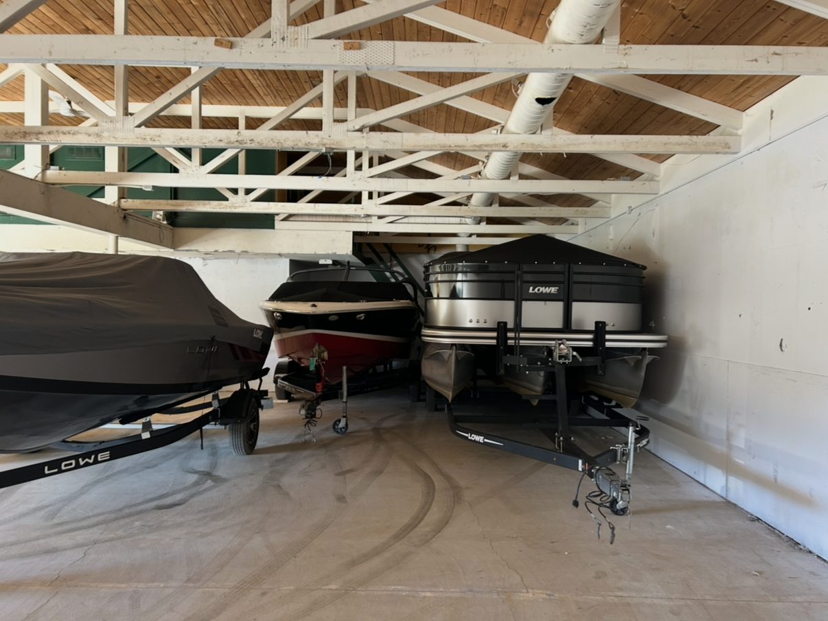 Boats and a pontoon inside the Boatworks indoor storage building